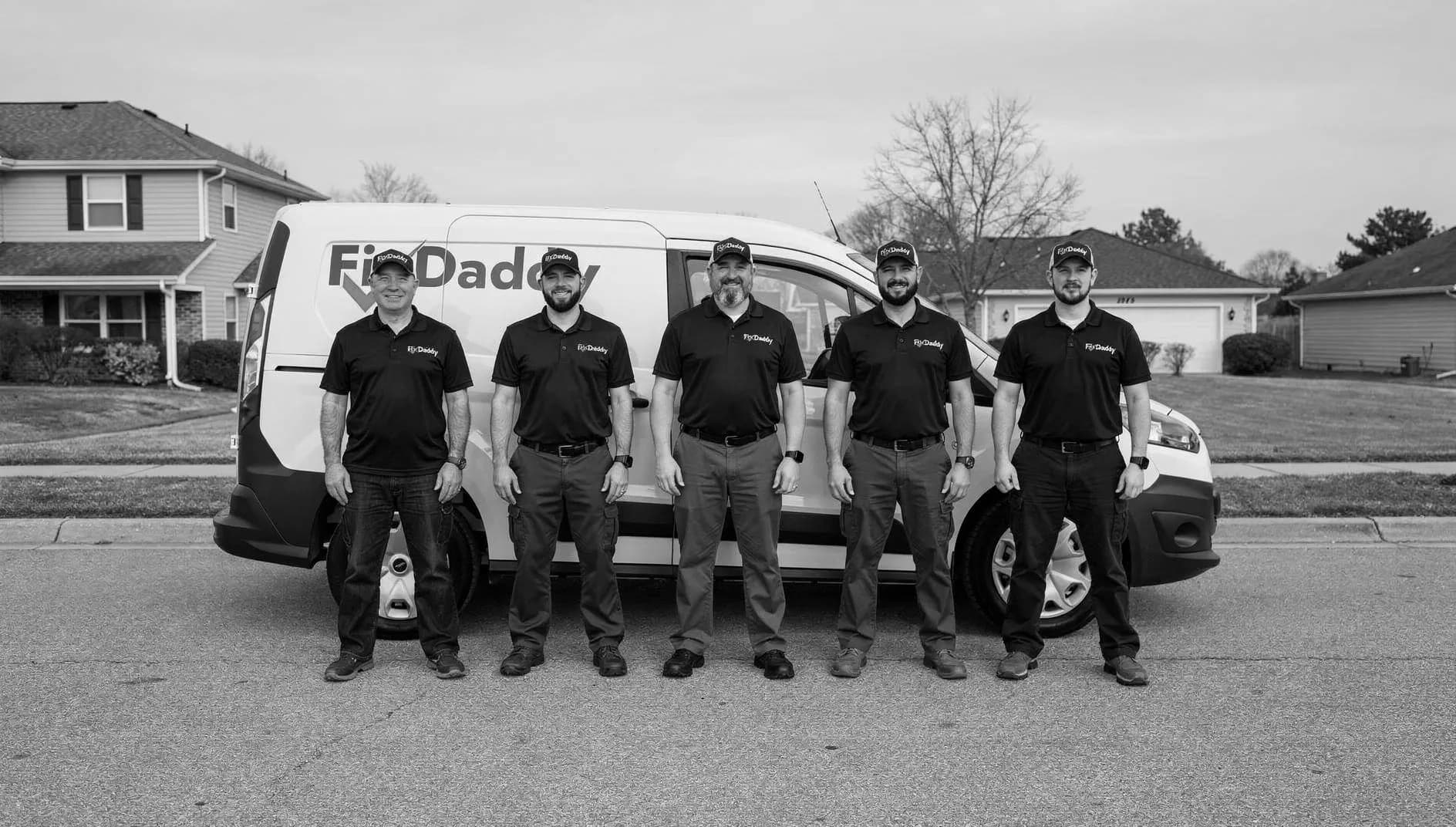 The FixDaddy team in uniform, standing in front of the FixDaddy service van