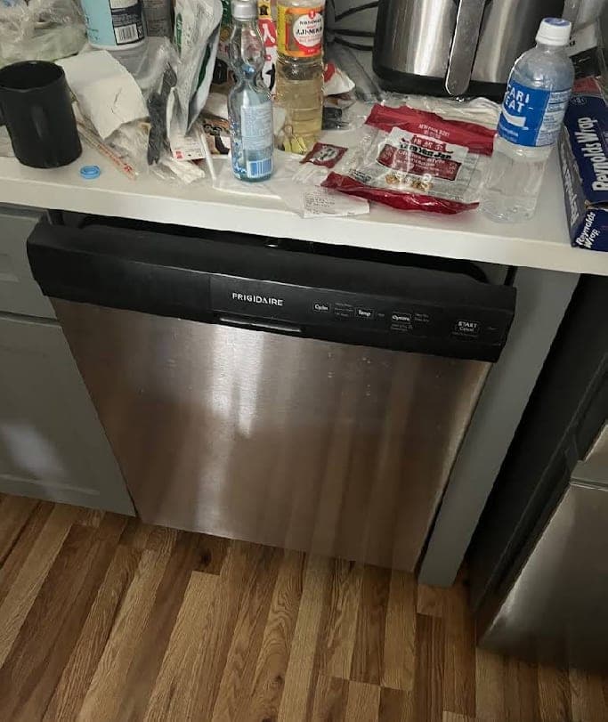 Frigidaire dishwasher repair in Vienna, VA — Drain pump seized, standing water pooled at the bottom of the tub