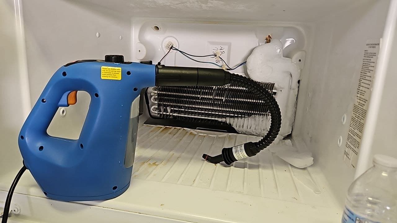 Frigidaire freezer repair in Ashburn, VA — Freezer drain line frozen, water under the bin