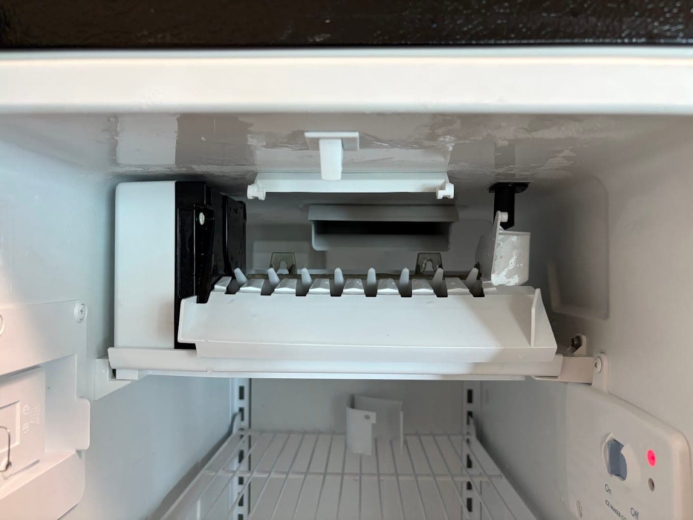 GE ice maker repair in Washington, DC, DC — An ice maker not filling, with heavy rear frost