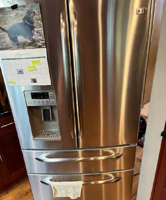 GE Profile refrigerator repair in Arlington, VA — Ice maker leaking water into the ice bin, entire ice supply freezing into one solid block