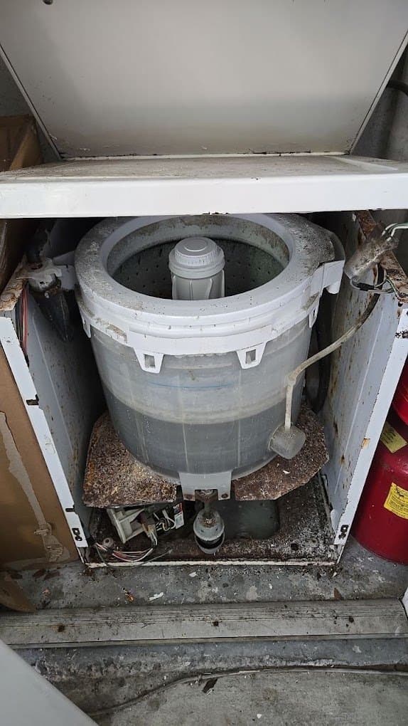 Kenmore washer repair in Woodbridge, VA — Top-load washer leaking from the bottom