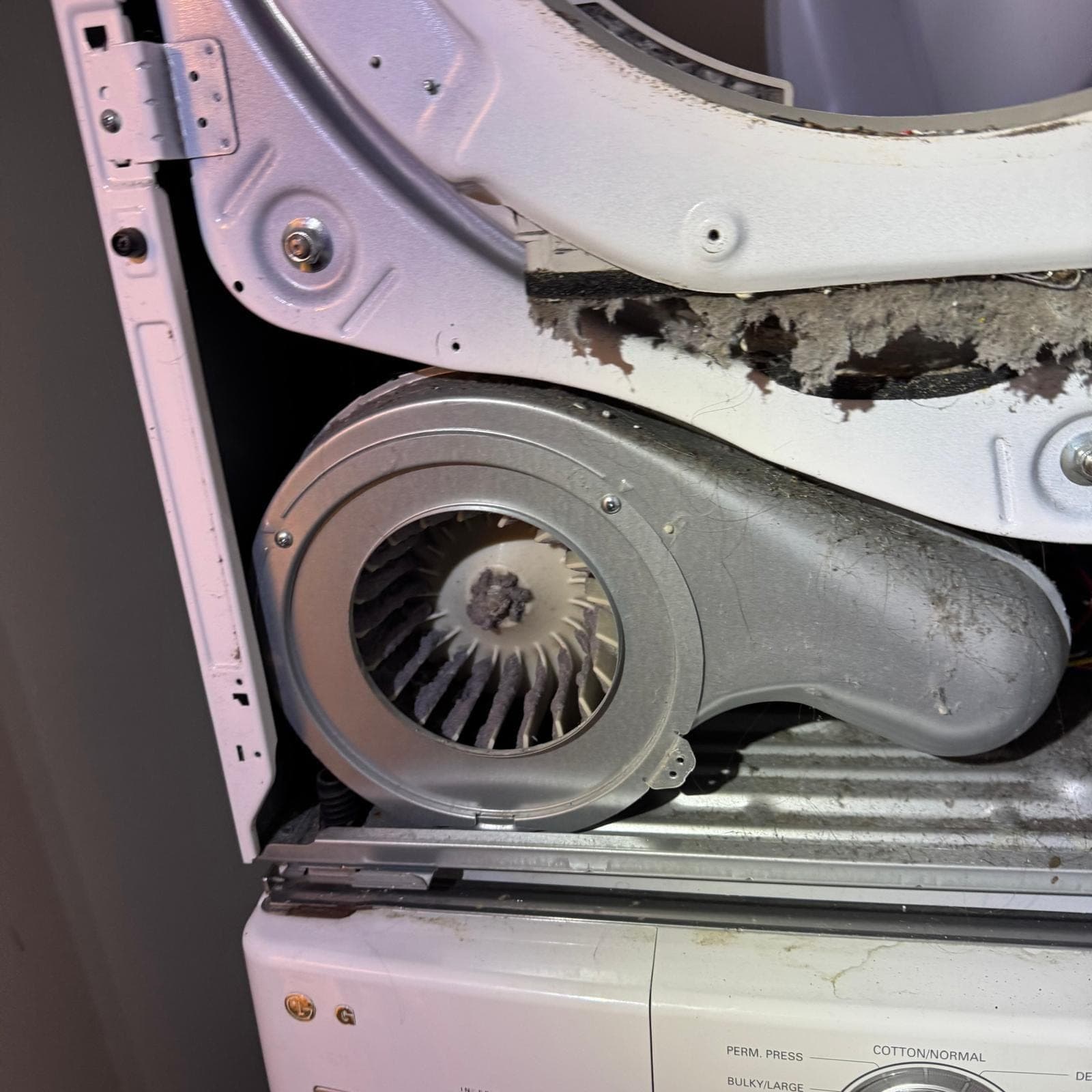 LG dryer repair in Great Falls, VA — Blower wheel clogged with lint and airflow fully blocked
