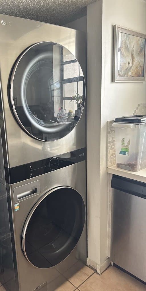 LG laundry combo repair in Herndon, VA — Washer in a single-unit laundry tower leaking