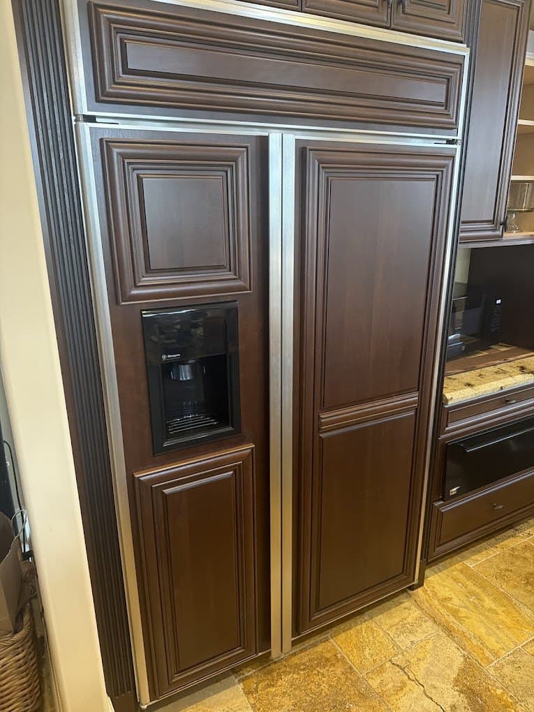 Monogram refrigerator repair in Potomac, MD — Dispenser side of a built-in running warm
