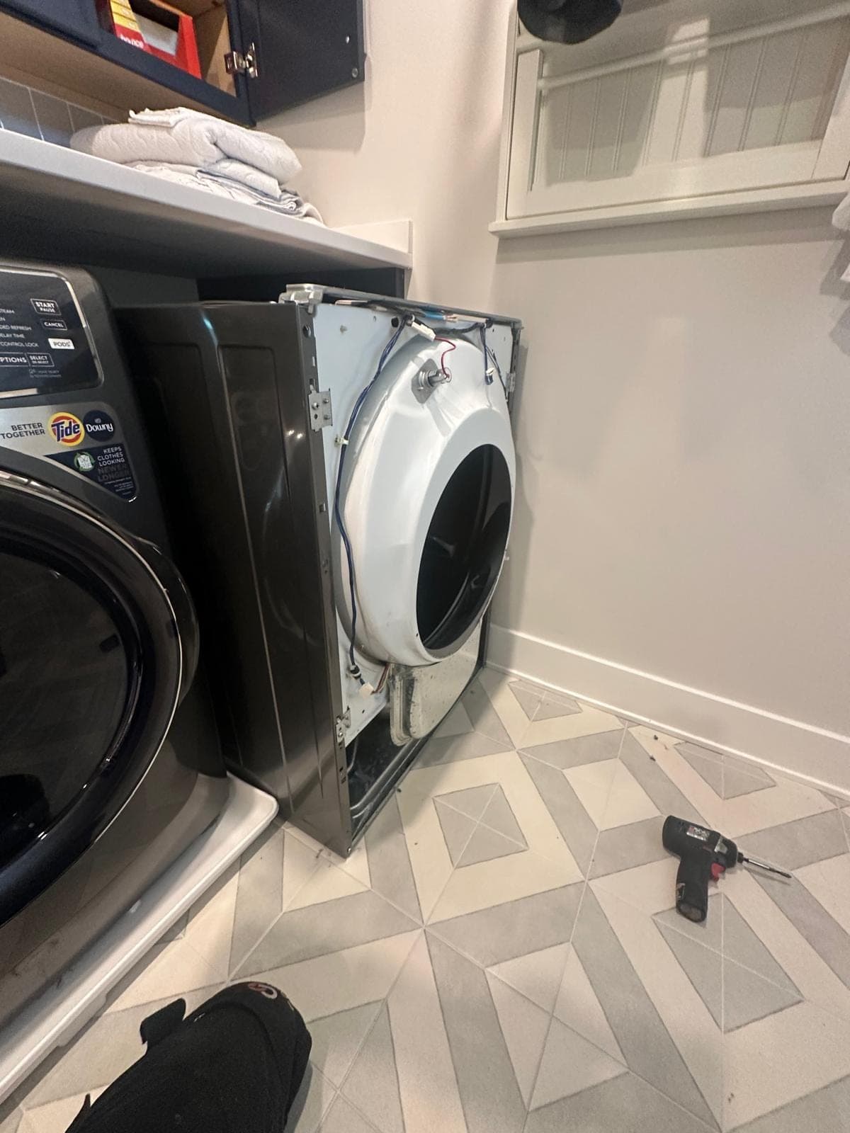 Samsung dryer repair in Fairfax, VA — The front panel removed, exposing the drum bearing and wiring harness