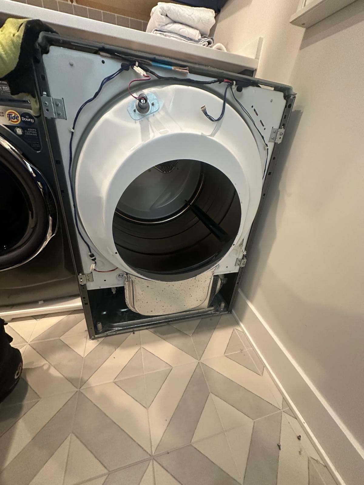 Samsung dryer repair in McLean, VA — A failed heating element and front panel removed for diagnosis