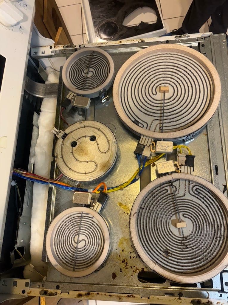 Whirlpool cooktop repair in Annandale, VA — A radiant element burned open under the glass