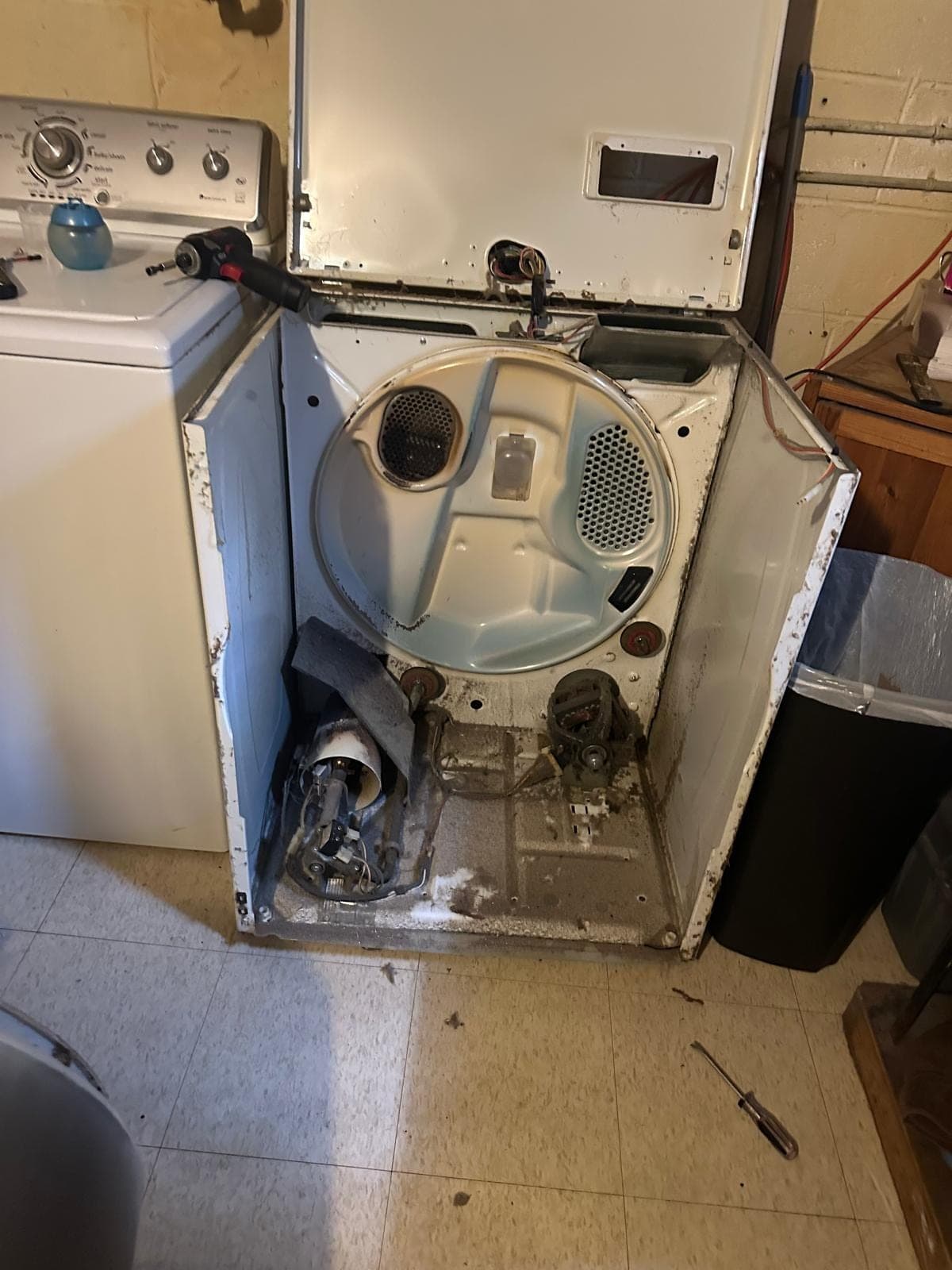 Whirlpool dryer repair in Vienna, VA — The cabinet fully disassembled, drum removed, and motor assembly exposed