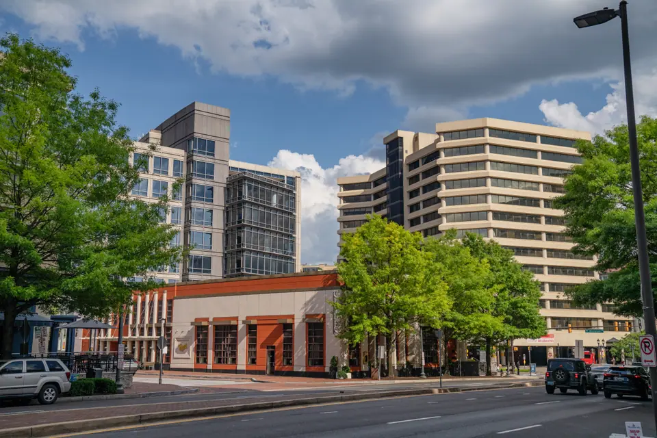 Wisconsin Avenue in Chevy Chase, Maryland, near Friendship Heights, with Clyde's of Chevy Chase and office buildings under a partly cloudy sky