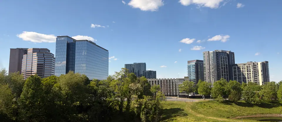 The Tysons, Virginia skyline of office and apartment towers rising above the trees on a clear day