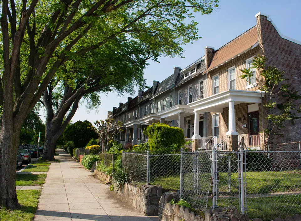 Brick rowhouses with front porches on a tree-lined block of Kentucky Avenue SE in the Barney Circle neighborhood near Capitol Hill, Washington, DC